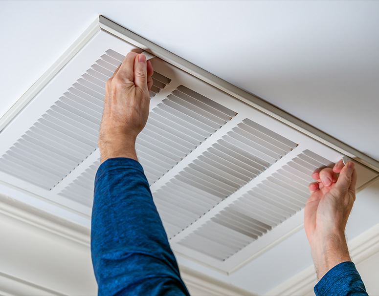HVAC technician performing professional duct cleaning service in San Antonio home