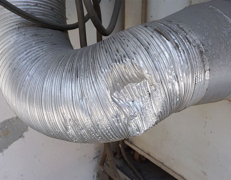 HVAC technician replacing ductwork in San Antonio home for improved airflow